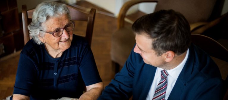 Elderly woman talking to attorney