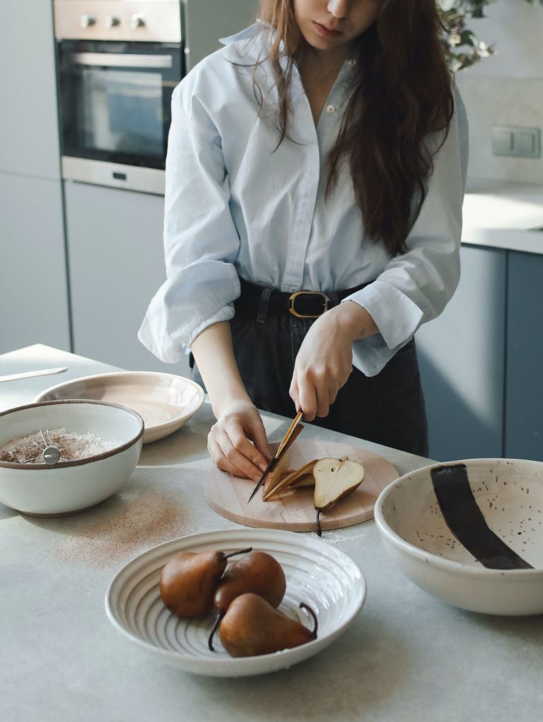 woman slicing pears in kitchen