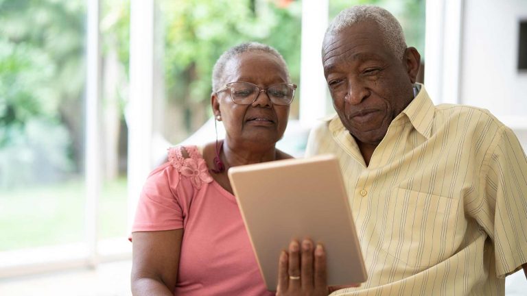 seniors holding tablet