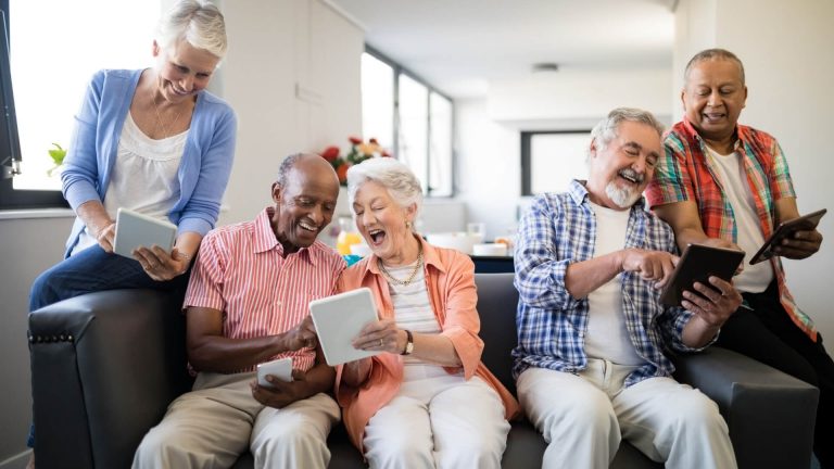 Seniors On Couch with tablets