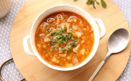 vegetable soup on a platter with a spoon