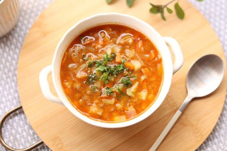 vegetable soup on a platter with a spoon