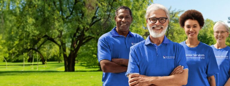 four volunteers in the park wearing blue shirts