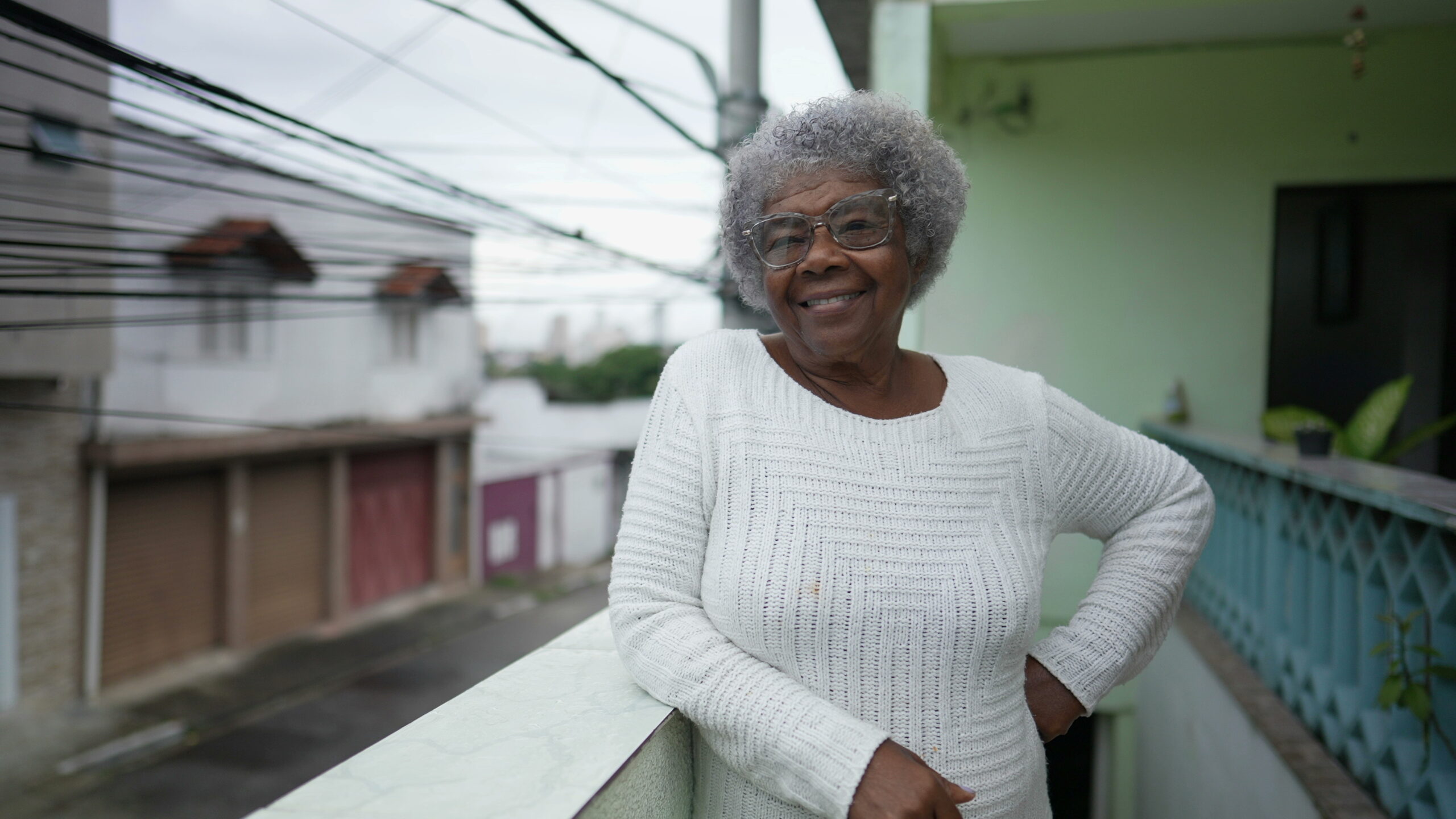 african american woman standing on patio smiling