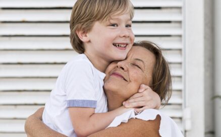 grandmother hugging grandson